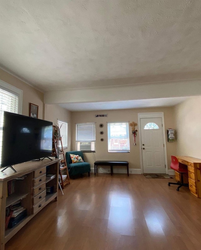 6910 68th St, Glendale, NY 11385 - living room featuring wood finished floors, healthy amount of natural light, a textured ceiling, and an office area