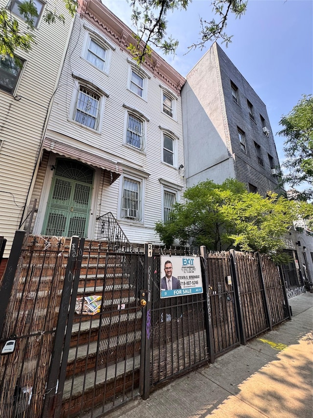 21 Jefferson St, Brooklyn, NY 11206 - view of building exterior with a fenced front yard