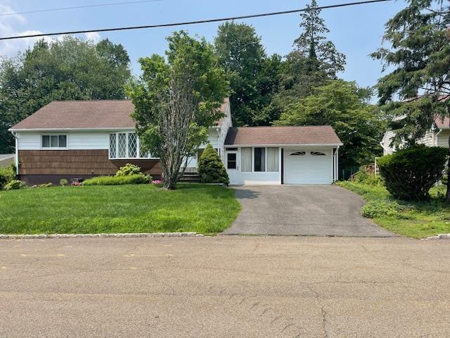 23 Elm St, Garnerville, NY 10923 - view of front of property with driveway, a garage, and a front yard