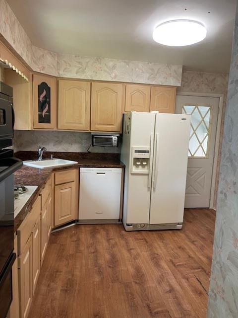 23 Elm St, Garnerville, NY 10923 - kitchen with white appliances, light brown cabinetry, wood finished floors, dark countertops, and wallpapered walls