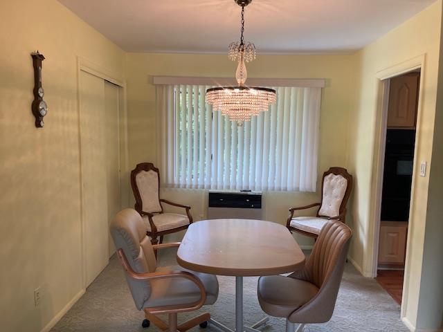 23 Elm St, Garnerville, NY 10923 - dining area featuring a chandelier and carpet