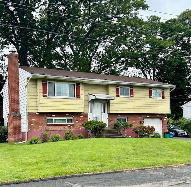 25 Waldron Dr, Stony Point, NY 10980 - bi-level home with a chimney, brick siding, a garage, and a front lawn