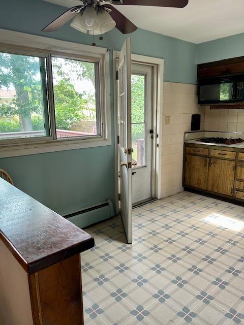 25 Waldron Dr, Stony Point, NY 10980 - kitchen featuring black microwave, a ceiling fan, baseboard heating, gas cooktop, and brown cabinetry