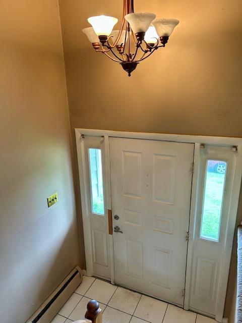 25 Waldron Dr, Stony Point, NY 10980 - entrance foyer with a baseboard radiator, light tile patterned floors, and a chandelier