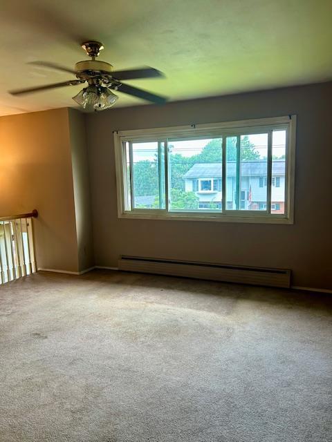25 Waldron Dr, Stony Point, NY 10980 - carpeted spare room with a baseboard heating unit, plenty of natural light, and ceiling fan
