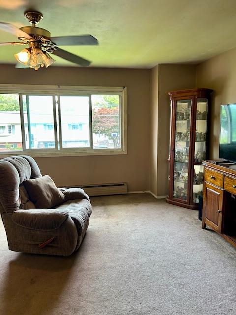 25 Waldron Dr, Stony Point, NY 10980 - living area with plenty of natural light, light carpet, a ceiling fan, and baseboard heating