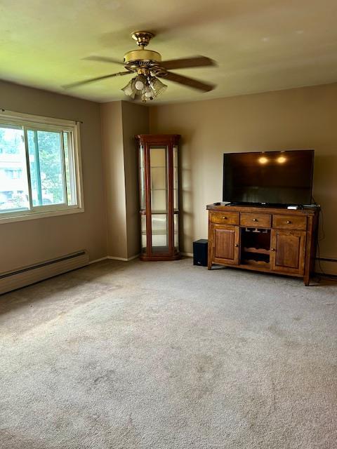 25 Waldron Dr, Stony Point, NY 10980 - unfurnished living room with a ceiling fan, light colored carpet, and baseboard heating