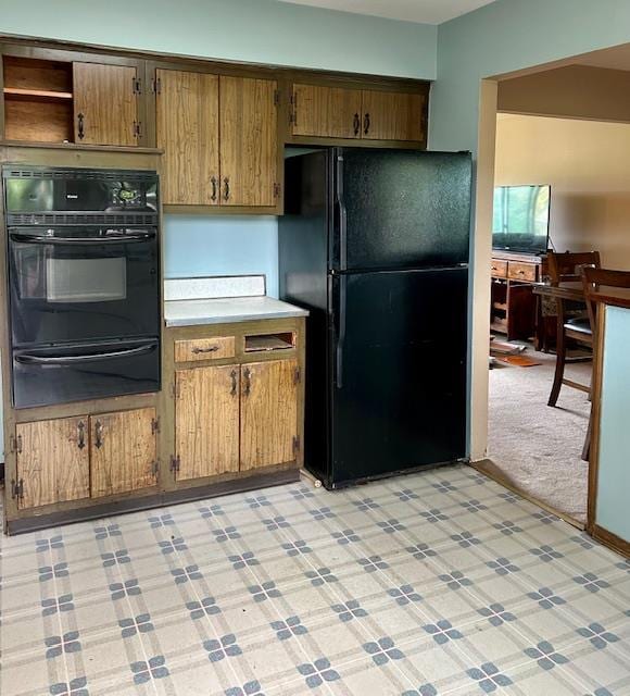 25 Waldron Dr, Stony Point, NY 10980 - kitchen featuring black appliances, a warming drawer, light countertops, light flooring, and brown cabinetry