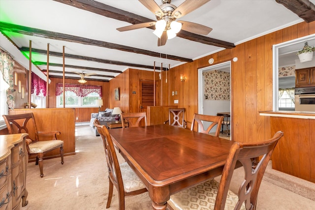 475 Emerson St, Uniondale, NY 11553 - dining area with ceiling fan, beamed ceiling, wood walls, light colored carpet, and a baseboard radiator