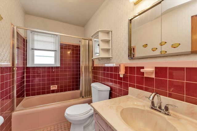 475 Emerson St, Uniondale, NY 11553 - full bathroom featuring vanity, wallpapered walls, bathing tub / shower combination, a wainscoted wall, and tile walls