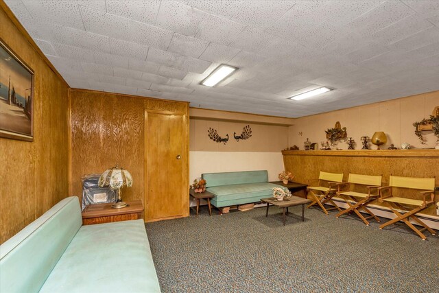 475 Emerson St, Uniondale, NY 11553 - carpeted living room featuring wood walls