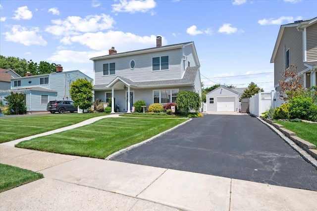 37 Swan Ln, Levittown, NY 11756 - view of front facade with a garage, an outbuilding, a chimney, and asphalt driveway