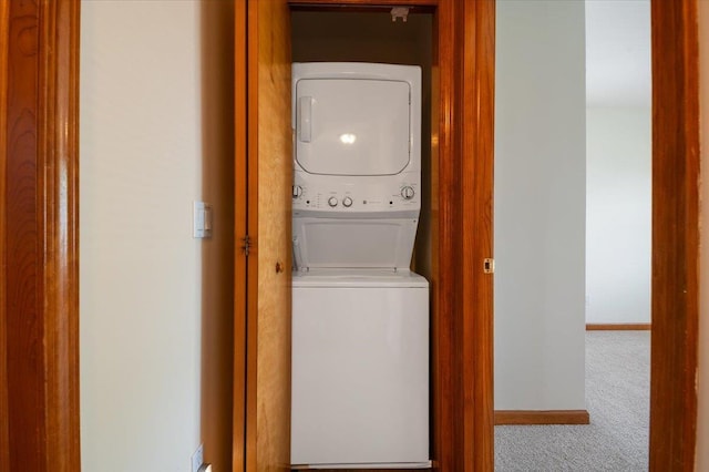 37 Swan Ln, Levittown, NY 11756 - washroom with stacked washer and clothes dryer and carpet flooring