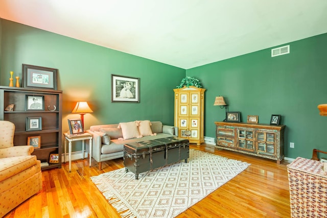 44 Croft Ln, Smithtown, NY 11787 - living area with wood finished floors, baseboards, and a baseboard radiator