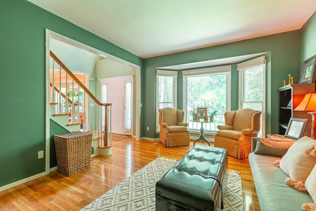 44 Croft Ln, Smithtown, NY 11787 - living area with baseboard heating, plenty of natural light, stairs, and wood finished floors