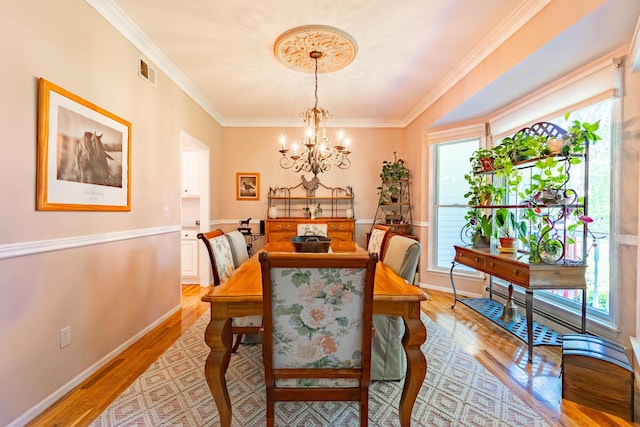 44 Croft Ln, Smithtown, NY 11787 - dining space featuring light wood-type flooring, a chandelier, crown molding, and baseboards