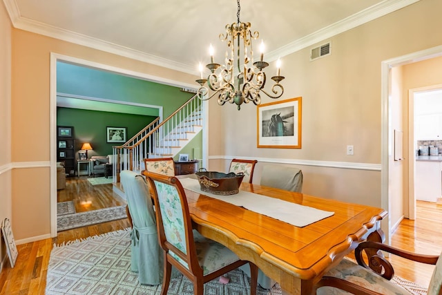 44 Croft Ln, Smithtown, NY 11787 - dining room with a chandelier, wood finished floors, stairway, crown molding, and baseboards