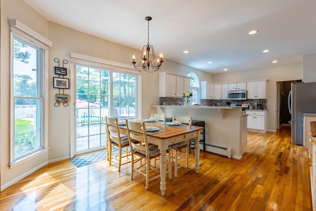 44 Croft Ln, Smithtown, NY 11787 - dining space featuring light wood-style floors, healthy amount of natural light, a chandelier, a baseboard heating unit, and recessed lighting