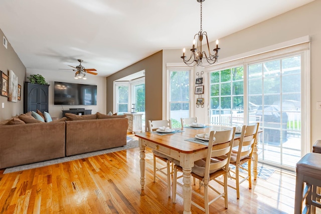 44 Croft Ln, Smithtown, NY 11787 - dining room with healthy amount of natural light, light wood finished floors, a chandelier, and a ceiling fan