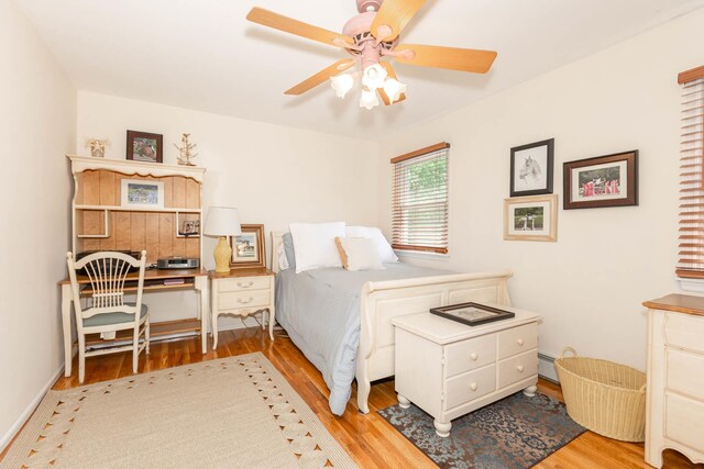 44 Croft Ln, Smithtown, NY 11787 - bedroom with wood finished floors, a baseboard radiator, ceiling fan, and baseboards