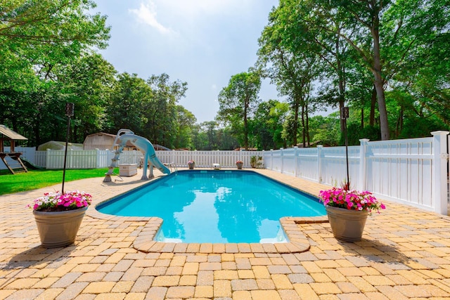 44 Croft Ln, Smithtown, NY 11787 - view of swimming pool with a water slide, a patio, a fenced backyard, and view of wooded area