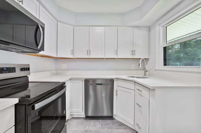 34 Warwick Pl Unit D, Yorktown Heights, NY 10598 - kitchen with stainless steel appliances, a sink, and white cabinets