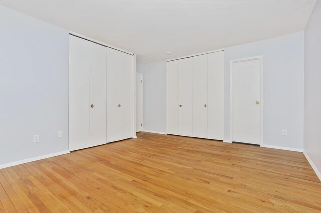 34 Warwick Pl Unit D, Yorktown Heights, NY 10598 - unfurnished bedroom with two closets, light wood-style flooring, and baseboards