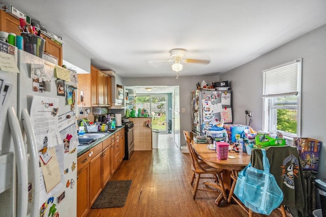 227 N Railroad Ave, Babylon, NY 11702 - kitchen with freestanding refrigerator, brown cabinets, wood finished floors, and ceiling fan