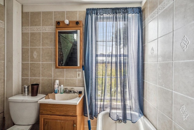 227 N Railroad Ave, Babylon, NY 11702 - bathroom featuring tile walls, vanity, plenty of natural light, and backsplash