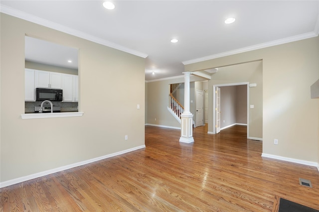 38 Woodside Knolls Dr, Middletown, NY 10940 - spare room with decorative columns, ornamental molding, light wood finished floors, recessed lighting, and stairway