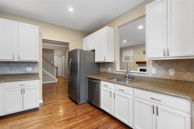 38 Woodside Knolls Dr, Middletown, NY 10940 - kitchen featuring appliances with stainless steel finishes, white cabinets, tasteful backsplash, light wood-style floors, and recessed lighting