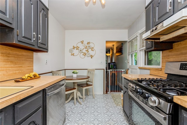 52 Newkirk Rd, Yonkers, NY 10710 - kitchen with stainless steel appliances, extractor fan, butcher block countertops, tasteful backsplash, and gray cabinets