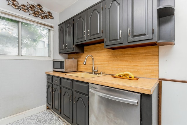 52 Newkirk Rd, Yonkers, NY 10710 - kitchen featuring appliances with stainless steel finishes, backsplash, gray cabinetry, and wooden counters
