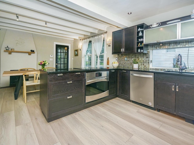 20 Oldwood Rd, Port Washington, NY 11050 - kitchen with stainless steel appliances, dark countertops, light wood-type flooring, open shelves, and beam ceiling
