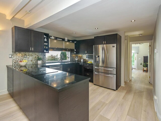 20 Oldwood Rd, Port Washington, NY 11050 - kitchen featuring stainless steel appliances, light wood-type flooring, a peninsula, plenty of natural light, and recessed lighting