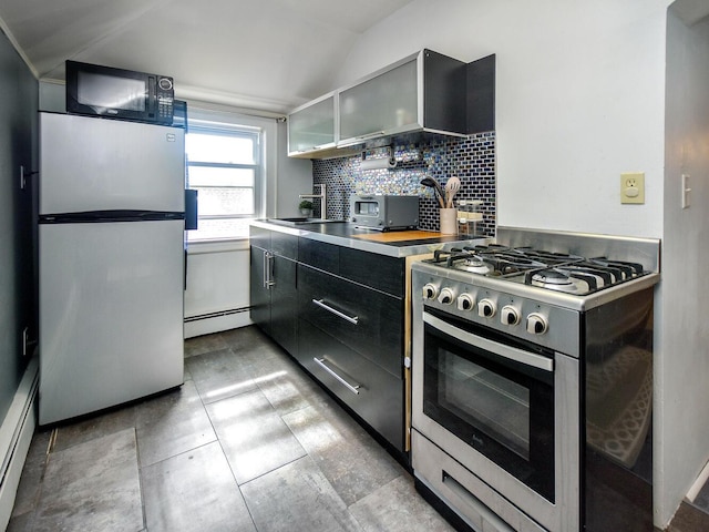 20 Oldwood Rd, Port Washington, NY 11050 - kitchen with stainless steel appliances, dark cabinets, backsplash, a baseboard heating unit, and lofted ceiling