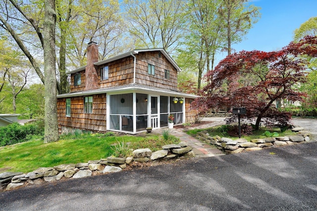 23 Cedar Ledges, Putnam Valley, NY 10579 - back of property with a sunroom and a chimney