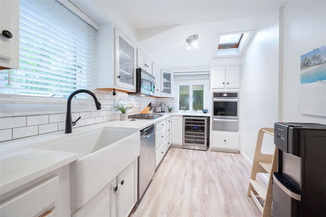 23 Cedar Ledges, Putnam Valley, NY 10579 - kitchen featuring beverage cooler, stainless steel appliances, a warming drawer, tasteful backsplash, and a sink