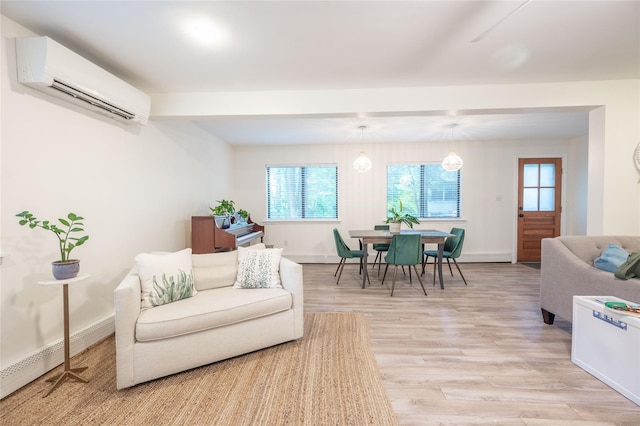 23 Cedar Ledges, Putnam Valley, NY 10579 - living room featuring a wall mounted air conditioner, a baseboard radiator, light wood-style floors, and baseboards
