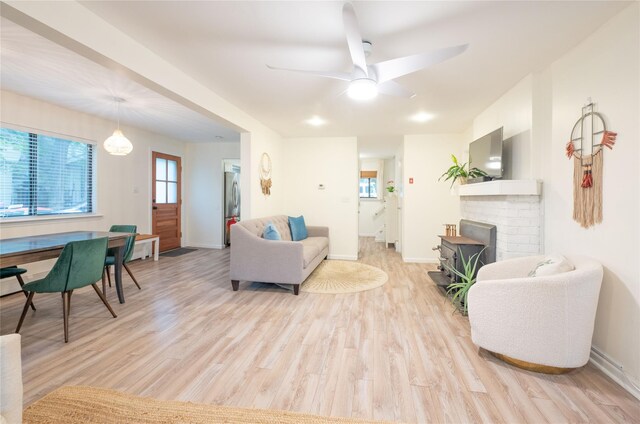 23 Cedar Ledges, Putnam Valley, NY 10579 - living area featuring light wood-style flooring, ceiling fan, baseboards, and a fireplace