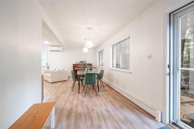 23 Cedar Ledges, Putnam Valley, NY 10579 - dining room featuring an AC wall unit, healthy amount of natural light, and light wood finished floors