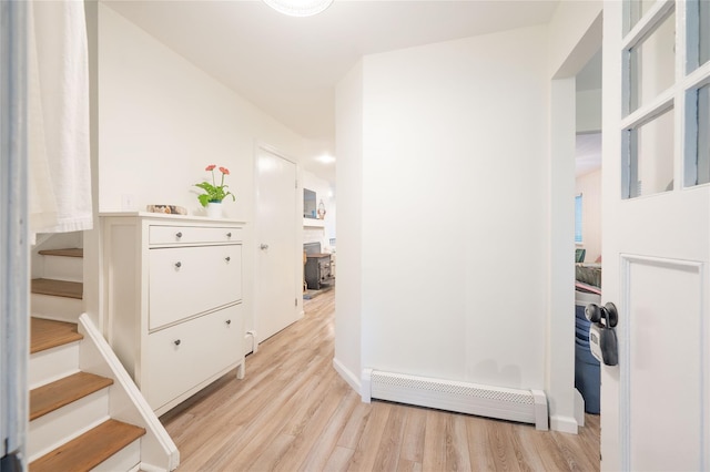 23 Cedar Ledges, Putnam Valley, NY 10579 - corridor with a baseboard heating unit, light wood-type flooring, stairs, and baseboards