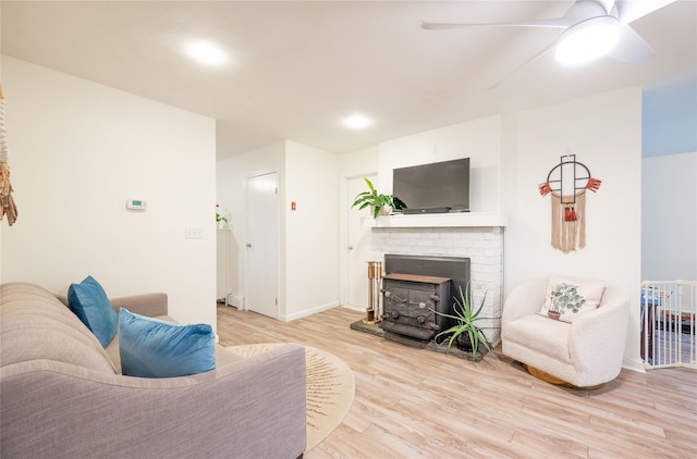 23 Cedar Ledges, Putnam Valley, NY 10579 - living room with light wood-style flooring, ceiling fan, a fireplace, and baseboards