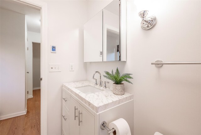 23 Cedar Ledges, Putnam Valley, NY 10579 - half bath featuring wood finished floors, vanity, baseboards, and toilet