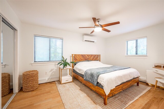 23 Cedar Ledges, Putnam Valley, NY 10579 - bedroom featuring a wall mounted AC, multiple windows, and light wood-style floors