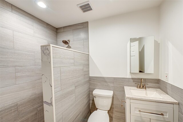 1350 Islip Ave, Brentwood, NY 11717 - bathroom with vanity, tile walls, tiled shower, and wainscoting