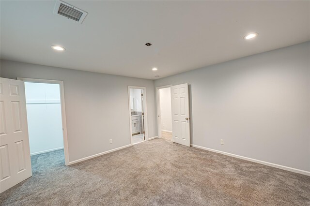 1350 Islip Ave, Brentwood, NY 11717 - unfurnished bedroom with a spacious closet, carpet, recessed lighting, and ensuite bath
