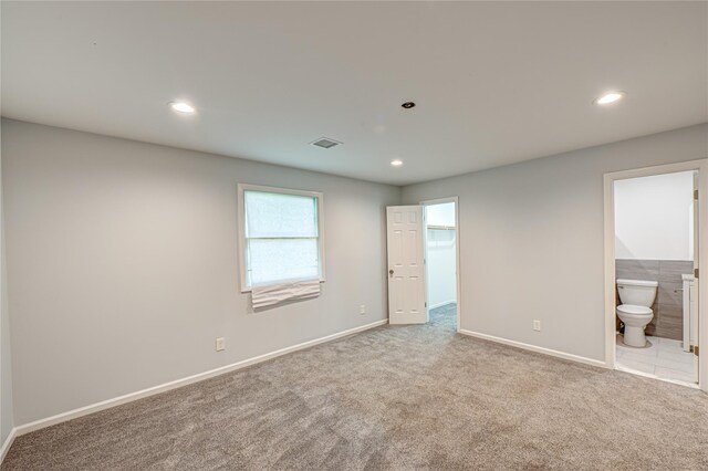 1350 Islip Ave, Brentwood, NY 11717 - unfurnished bedroom with carpet floors, connected bathroom, recessed lighting, and a walk in closet