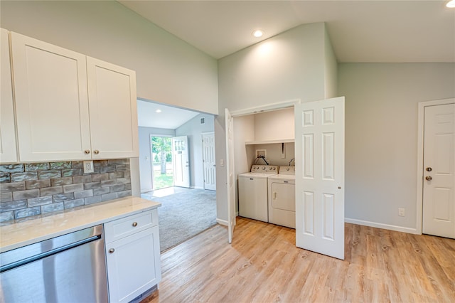 1350 Islip Ave, Brentwood, NY 11717 - kitchen with stainless steel dishwasher, lofted ceiling, white cabinets, light wood-style flooring, and decorative backsplash