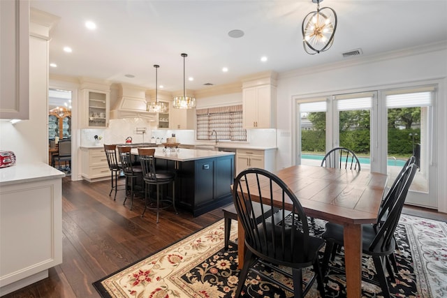 77 Crabapple Rd, Manhasset, NY 11030 - dining space featuring crown molding, dark wood-style flooring, a chandelier, and recessed lighting